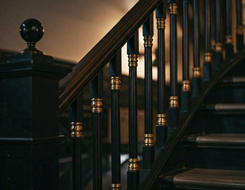 black bannister with gold accent metal