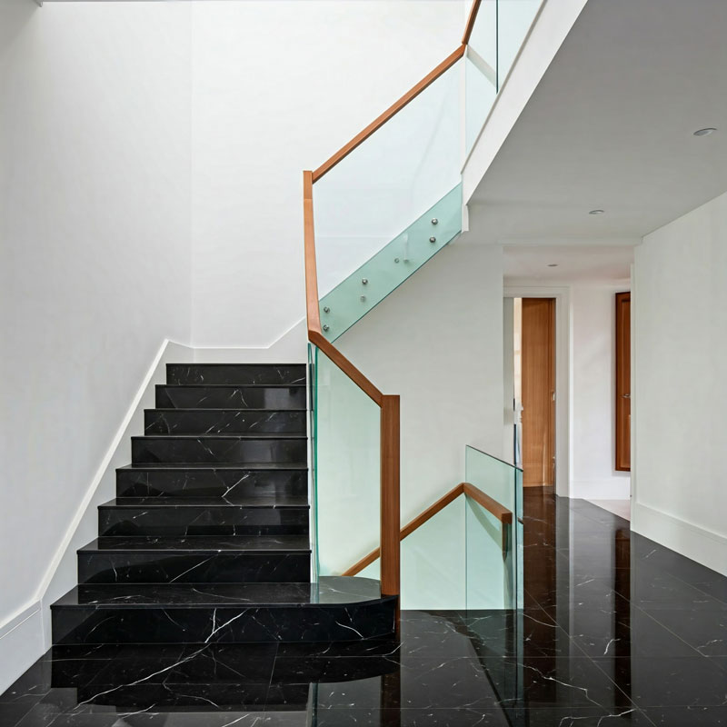 black marble stairs white walls timber banister